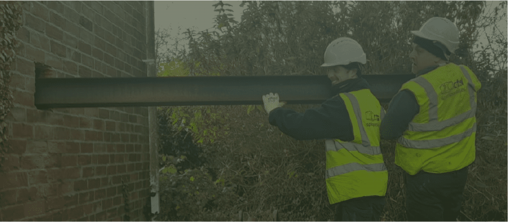 Rhyl base team members Warren & Mark installing steel beams on a large masonry replacement project following a domestic kerosene spill in North Wales