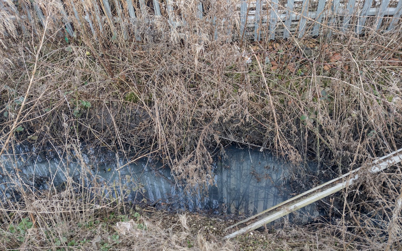 Contaminated drainage ditch on site at this Yorkshire agricultural business prior to kerosene spill clean up and remediation.