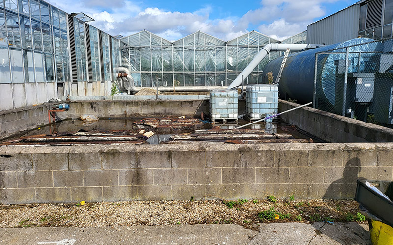 The fuel storage tank area following removal of the agriculture business's old fuel tanks, prior to digging out of contaminated materials and reinstatement to a solid concrete pad.