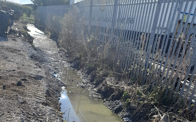 The policyholder's site boundary drainage ditch had been impacted by a substantial kerosene spill. CTSL Spill Specialists cleared the adjacent hedge before removing contaminated material from the ditch.