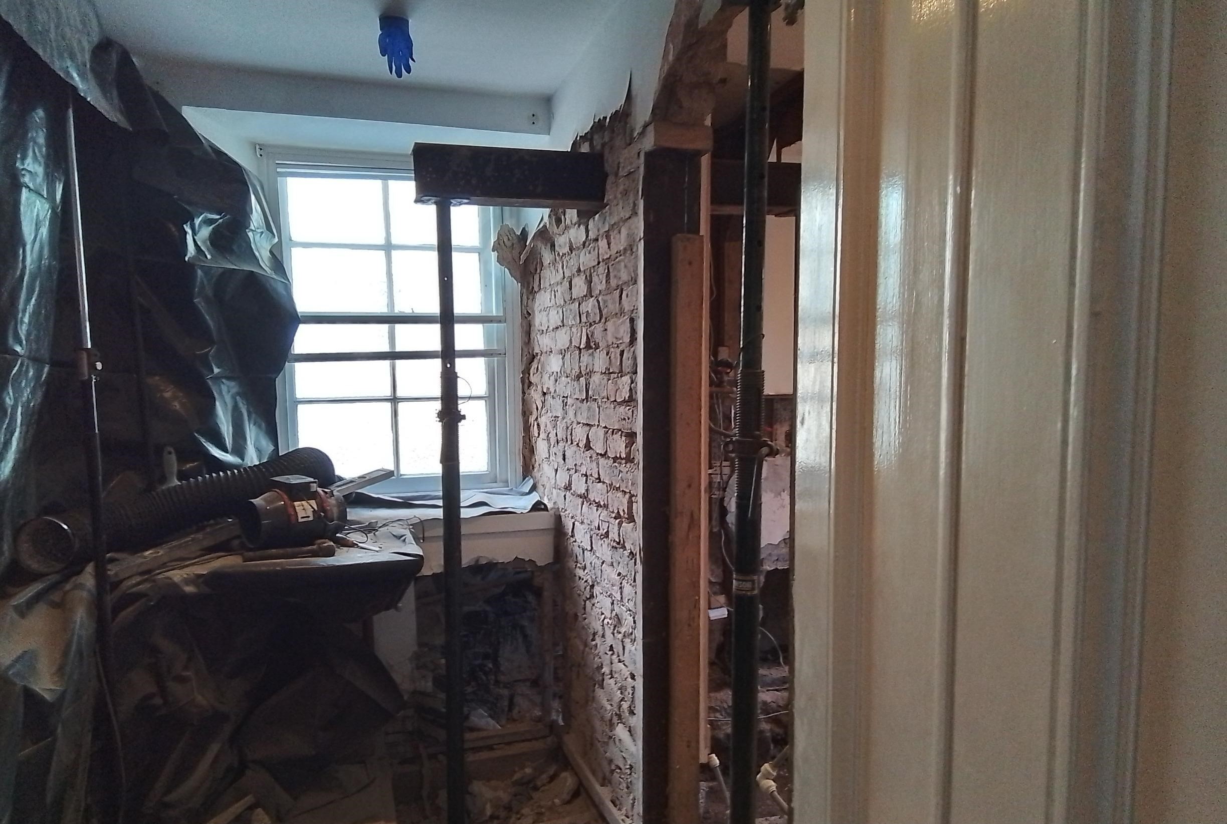 As our team worked through the homes structures, a disused fireplace was taken down, the wall supported and rebuilt following removal of contaminated material