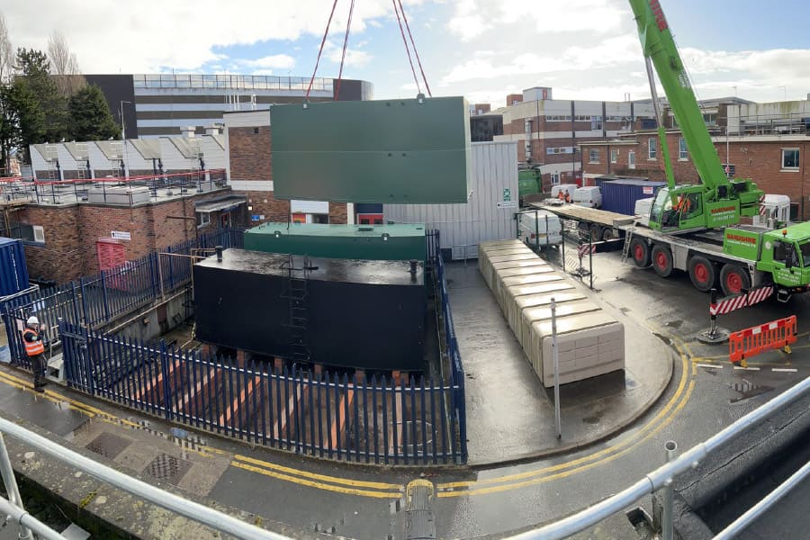 Photo of large fuel tank being crane lifted into position at large hospital in the North West of England