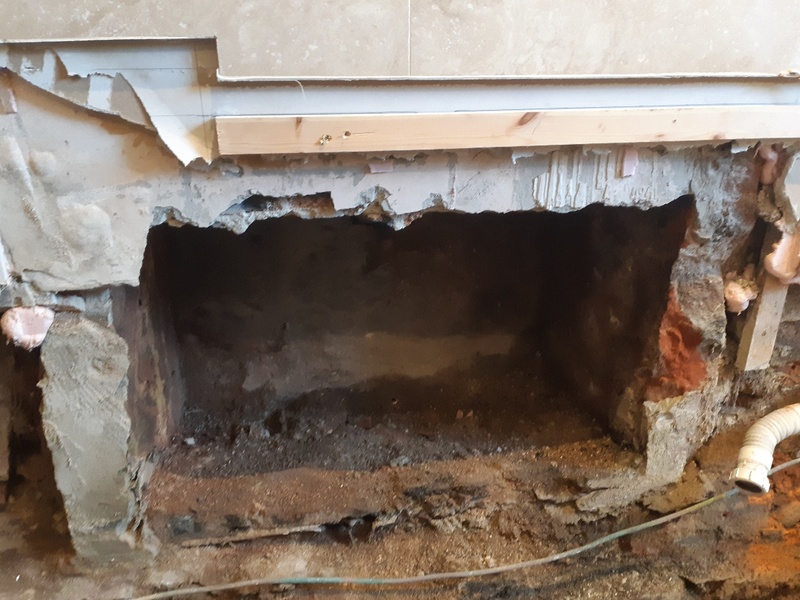 A disused fireplace is discovered by CTSL Spill Specialists’ buildings team during works to remove contaminated structures from the affected bathroom following an oil spill from an internal oil supply pipe at this home in Scotland