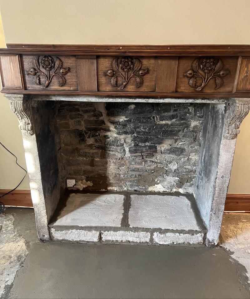 Our CTSL Spill Specialists team’s completed, reinstated stone fireplace hearth, constructed using stone in a style sympathetic to the original, with the original surround still in place and unharmed